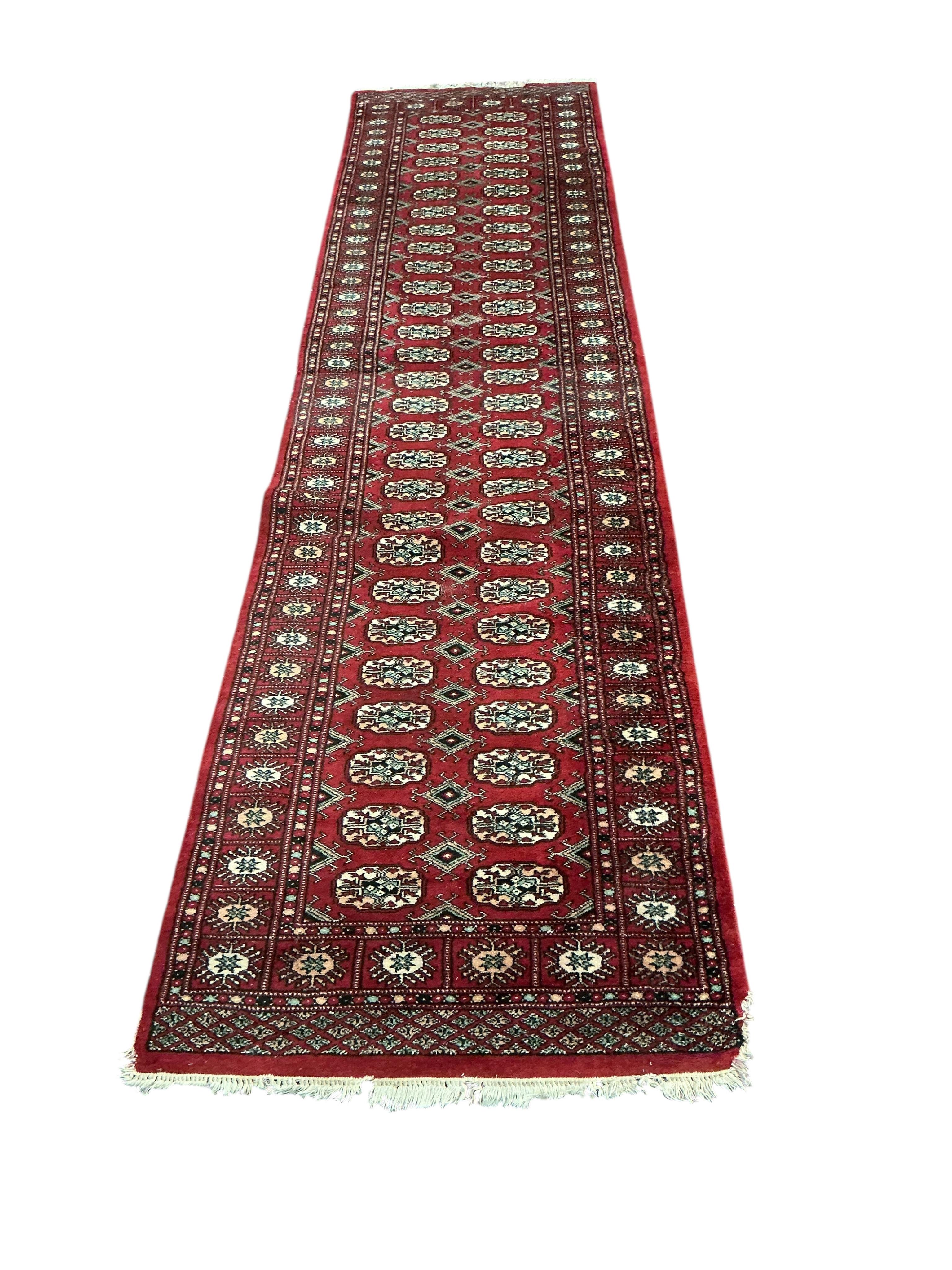 A Bokhara red ground runner and smaller rug, larger 300 x 78cm
